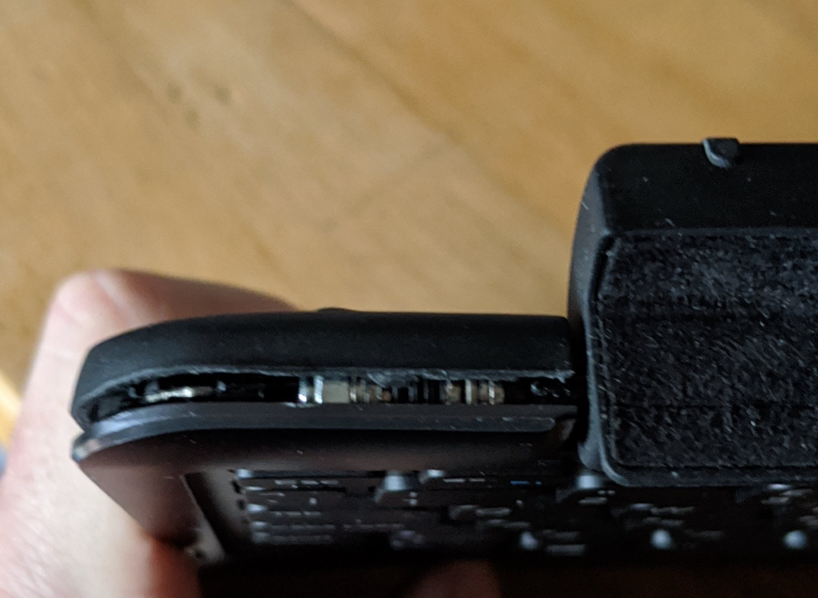 Keyboard case being prised open along the edge next to the hinge