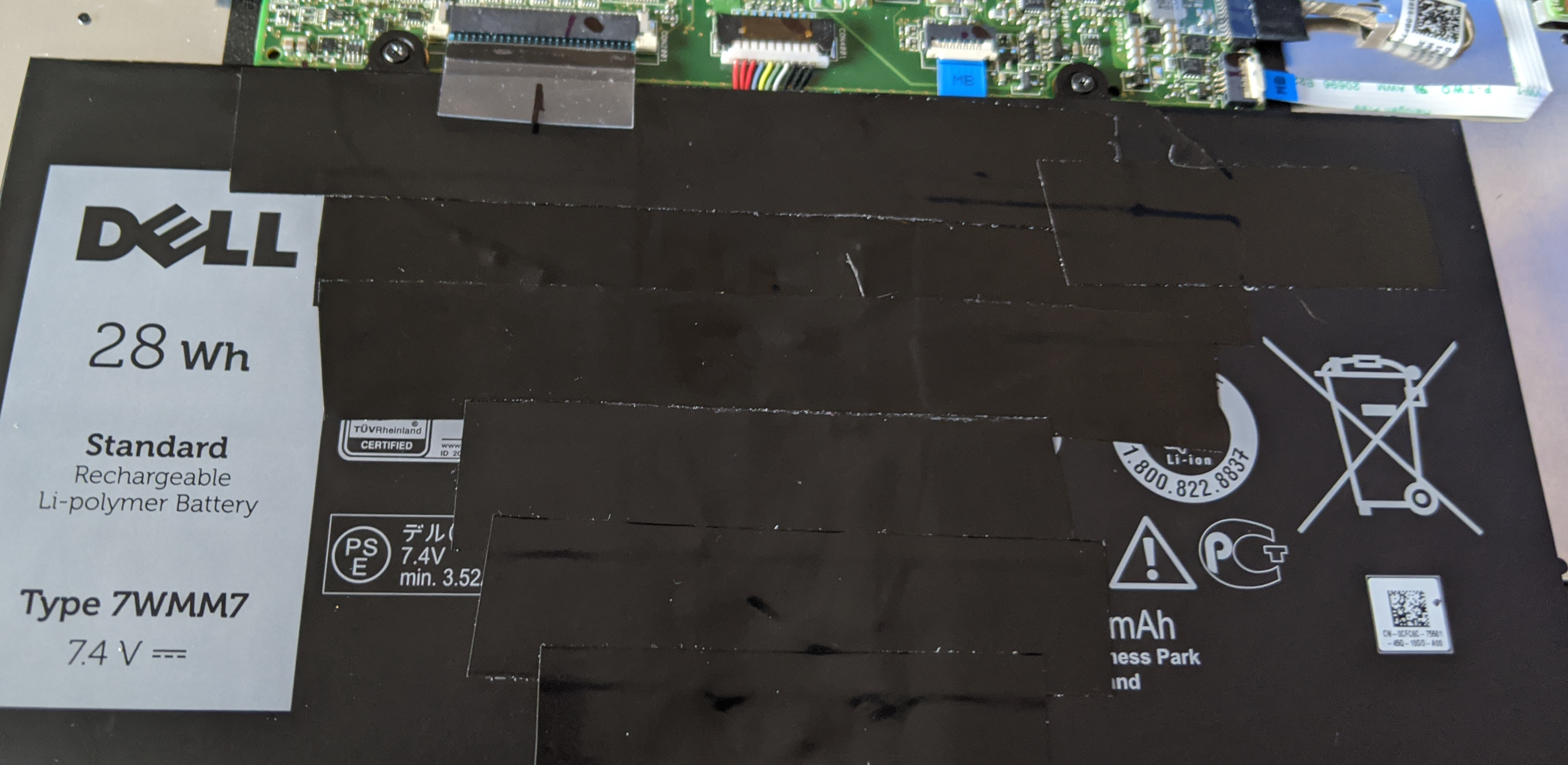 Battery pack taped back up with black tape, ready to reassemble